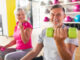 The senior couple is happy to exercise their arms.