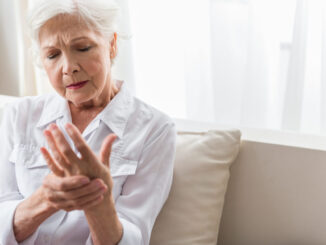 The older woman suffers from hand pain.